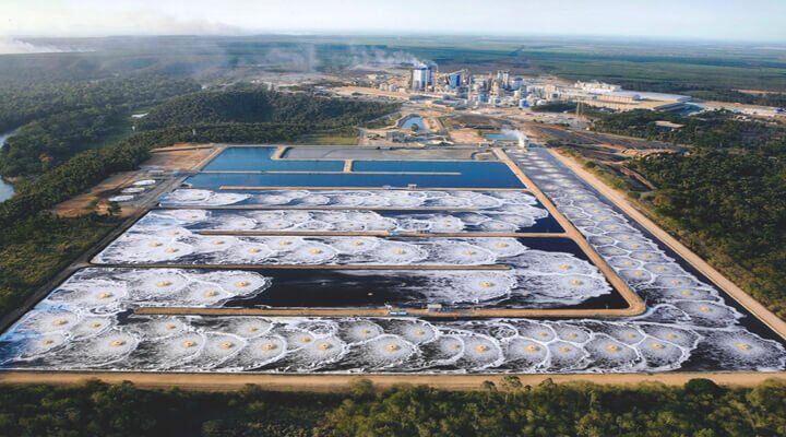 Aerobic Granular Sludge Technology: The Future Of Wastewater Treatment 1 Aerial view of large industrial wastewater treatment ponds showing biological aeration and settling patterns, illustrating the application of aerobic granular sludge technology.