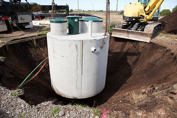 How Do Enzymes Work to Maintain and Clean Your Septic Tank 1 Environmentally friendly septic tank being lowered into ground
