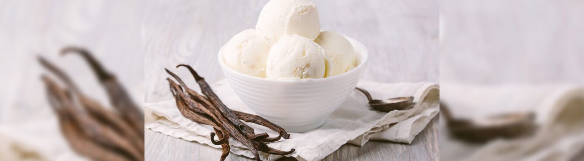 How Organica's Magic Gro Plus Can Boost Vanilla Plantation 1 Fresh vanilla beans with a bowl of vanilla ice cream, representing the high-quality produce from healthy vanilla plantations using Magic Gro Plus.
