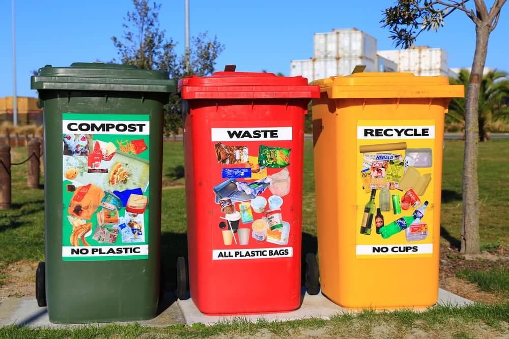 Solid Waste Disposal: 5 Simple Ways to Reduce Waste at Home 1 Three bins labeled Compost, Waste, and Recycle with waste images, promoting solid waste disposal and reduction at home.