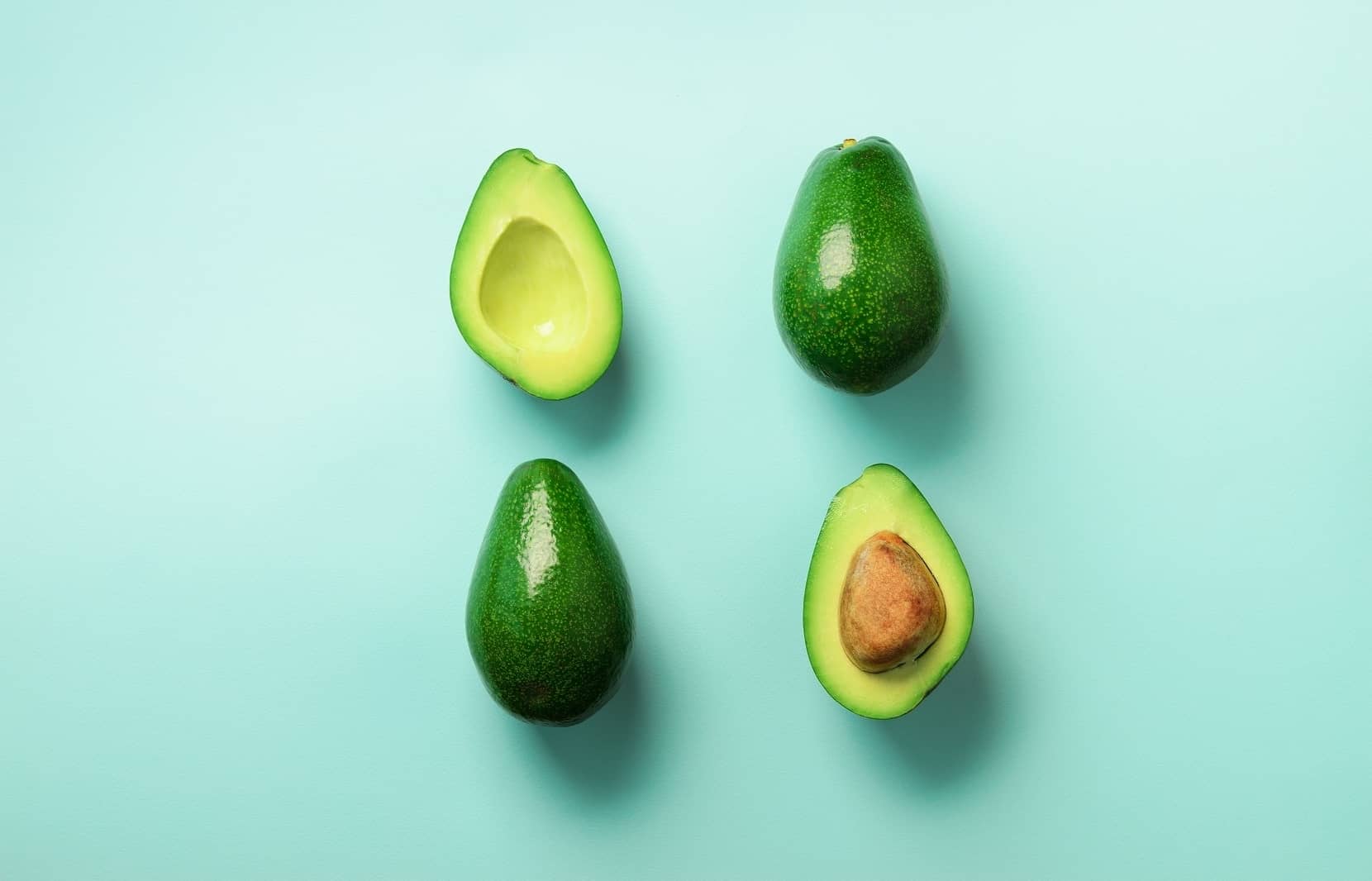 Building A More Sustainable Avocado Farm With Magic Gro Plus 1 Ripe whole and halved avocados, a superfood whose global demand necessitates sustainable farming practices and solutions like Magic Gro Plus.
