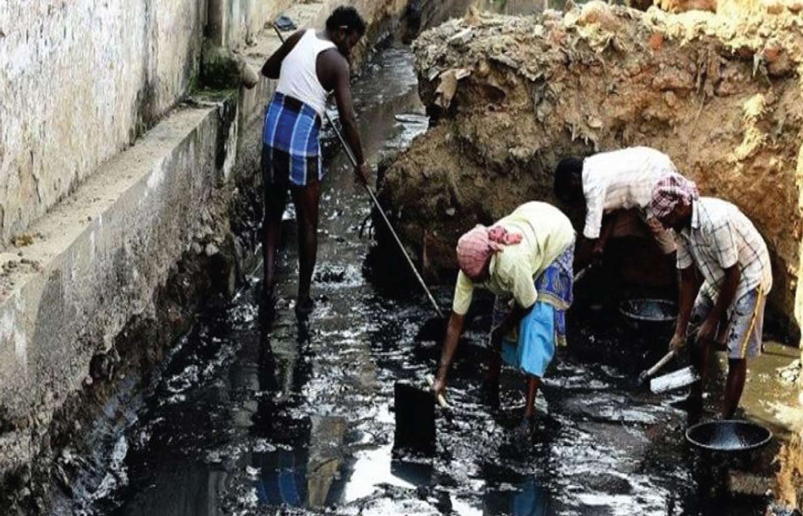 Cleaning Septic Tanks Without Loss Of Life 1 everal men wading in a heavily polluted, dark drain, manually cleaning it, representing sanitation challenges.