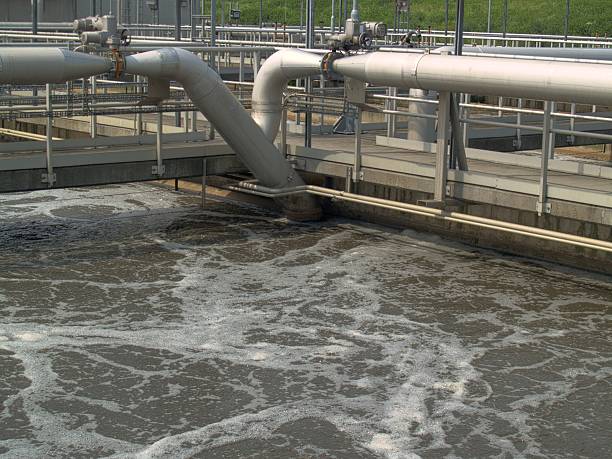 How is Biotechnology Used in Sewage Treatment 1 Wastewater treatment tank with pipes and aeration, processing water biologically