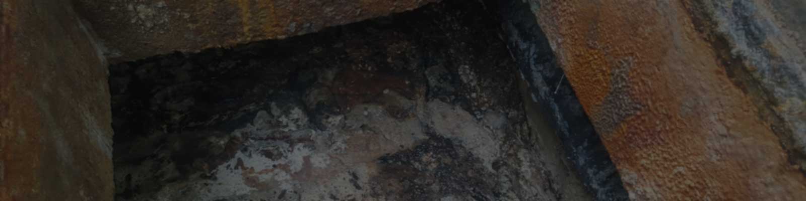 Close-up of a pipe or drain showing heavy grease and FOG (Fats, Oils, Grease) accumulation before CleanMaxx FOG treatment.